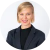 A woman in a suit smiling for the camera